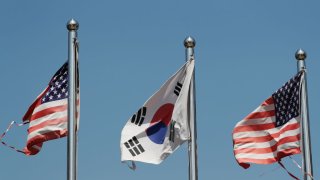 FILE - A South Korean national flag, center, and U.S. national flags