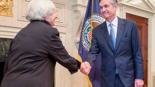 Federal Reserve Chair Janet Yellen (L) congratulates Fed Governor Jerome Powell at his swearing-in ceremony for a new term on the Fed’s board, in Washington in this handout photo taken and released June 16, 2014.