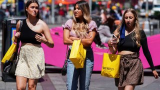 People walk without protective masks in Times Square amid the coronavirus disease (COVID-19) pandemic in the Manhattan borough of New York City, New York, U.S., May 4, 2021.