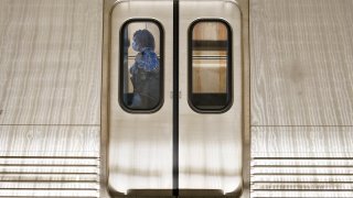 A passenger boards a train at Washington Metro's Dupont Circle station