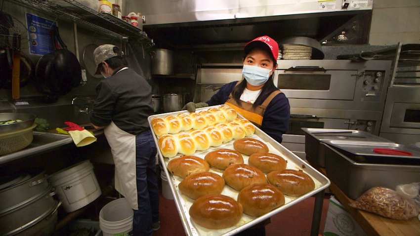 Hanna Zhang holds a tray of freshly baked buns in her ICafe on Waverly in San Francisco’s Chinatown.