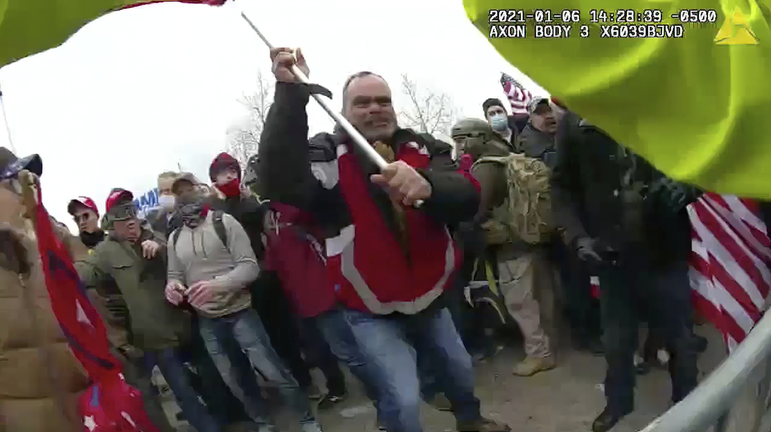 This still frame from Metropolitan Police Department body worn camera video shows Thomas Webster, in red jacket, at a barricade line at on the west front of the U.S. Capitol on Jan. 6, 2021, in Washington. Webster, a Marine Corps veteran and retired New York City Police Department Officer, is accused of assaulting an MPD officer with a flagpole. A number of law enforcement officers were assaulted while attempting to prevent rioters from entering the U.S. Capitol. (Metropolitan Police Department via AP)