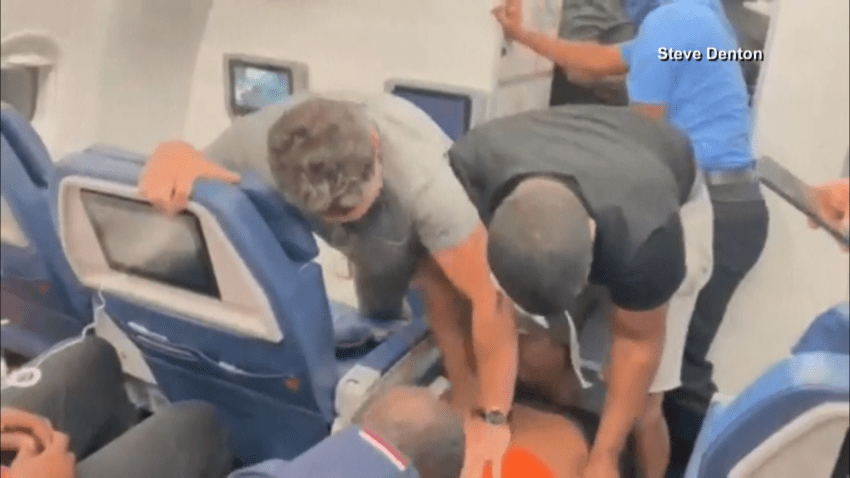 Passengers on a Delta flight stop an unruly passenger