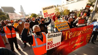 Jose Haro, Felipe Medina and Lou Villalvazo, left to right, with Teamsters Local 63 joined union workers as they rallied in downtown Los Angeles Monday morning in support of unionizing Alabama Amazon workers.
