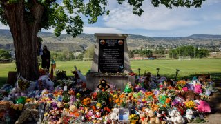 A makeshift memorial surrounding a monument