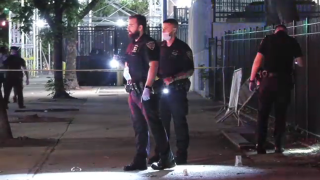 Police collect evidence after a fatal shooting on a Manhattan street.