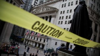 Caution tape hangs near the steps of Federal Hall across from the New York Stock Exchange in New York.