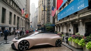 A vehicle from electric car maker NIO sits outside of the New York Stock Exchange (NYSE), September 12, 2018 in New York City.