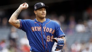 New York Mets pitcher Taijuan Walker throws to first base for an out on New York Yankees' DJ LeMahieu during the first inning of a baseball game on Saturday