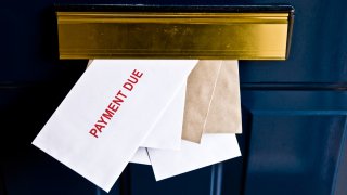 Letters in letterbox saying payment due