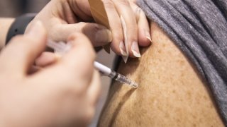 Injecting COVID vaccine in arm