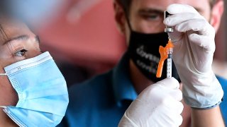 The Pfizer Covid-19 vaccine is prepared for administion at a mobile clinic in an East Los Angeles neighborhood which has shown lower vaccination rates especially among the young on July 9, 2021 in Los Angeles, California.