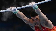 China's Chaopan Lin competes in the horizontal bars event of the artistic gymnastics men's team final during the Tokyo 2020 Olympic Games at the Ariake Gymnastics Centre in Tokyo on July 26, 2021.