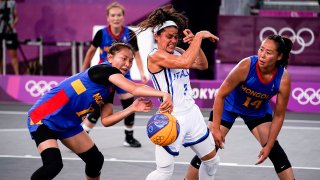 Jul 24, 2021; Tokyo, Japan; Mongolia's Khulan Onolbaatar (13) and Solongo Bayasgalan (14) defend against Italy's Raelin D Alie (3) in a 3x3 basketball game during the Tokyo 2020 Olympic Summer Games at Aomi Urban Sports Park.