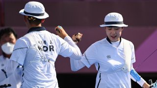 South Korea's Je-doek Kim and San An celebrate in the quarterfinals