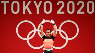 Dika Toua smiles after making history as first five-time female Olympian lifter