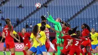Stephanie Labbe of Canada punches the ball during the Women's Olympic quarterfinal match between Canada and Brazil