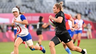New Zealand's Michaela Blyde runs past France's Camille Grassineau to score a try in the women's rugby sevens final