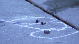 Three spent shell casings are circled by chalk as they lay on the street following a shooting in Philadelphia.
