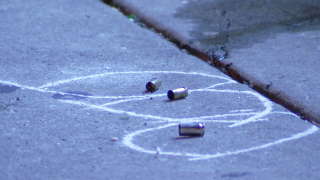 Three spent shell casings are circled by chalk as they lay on the street following a shooting in Philadelphia.