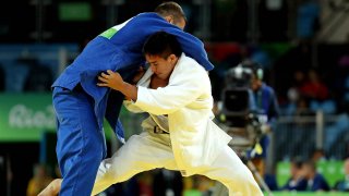 Aug 10, 2016; Rio de Janeiro, Brazil; Mashu Baker (JPN) fights Varlam Liparteliani (GEO) in the men's judo 90kg gold medal match in the Rio 2016 Summer Olympic Games at Carioca Arena 2.