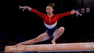 Sunisa Lee competes on the balance beam during the team final of the women's artistic gymnastics competition in Tokyo