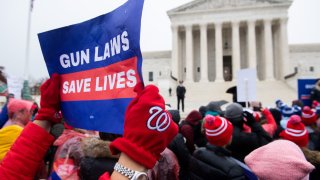 In this Dec. 2, 2019, file photo, supporters of gun control laws protest outside the US Supreme Court in Washington, DC.