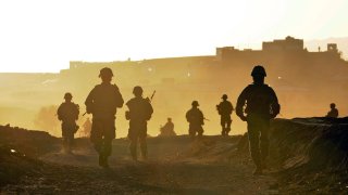 U.S. Soldiers and Airmen from Provincial Reconstruction Team Zabul return to base after a quality assurance, quality control patrol near the city of Qalat, Zabul province, Afghanistan, Nov. 1, 2010.