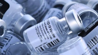 Empty vials of the Pfizer COVID-19 vaccine are seen at a first come first serve drive-thru vaccination site operated by the Lake County Health Department on January 28, 2021 in Groveland, Florida.