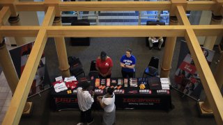 Job seekers speak with recruiters at a Job News USA career fair in Louisville, Kentucky, on June 23, 2021.