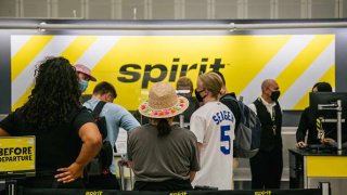People wait in line at a Spirit Airlines counter, at the George Bush Intercontinental Airport, on Aug. 5, 2021 in Houston, Texas.