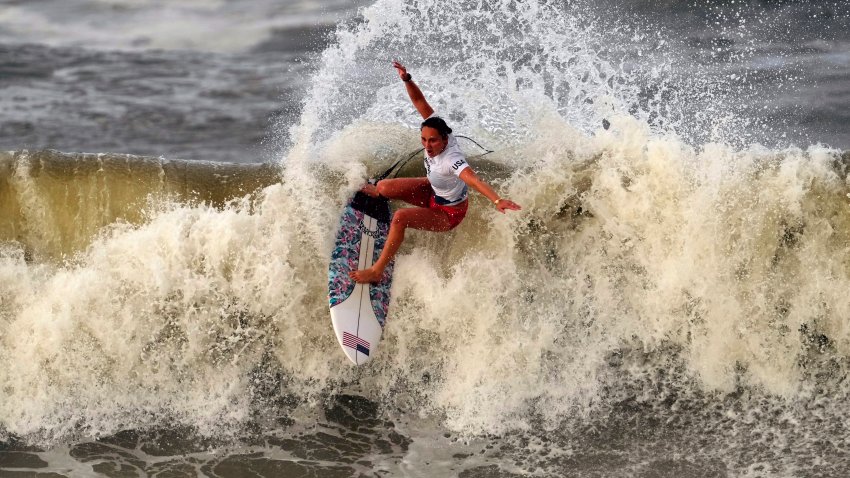 Carissa Moore, of the United States, preforms on the wave during the gold medal heat in the women's surfing competition at the 2020 Summer Olympics