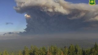 plumes of smoke rise from the Caldor Fire in El Dorado County, Calif.