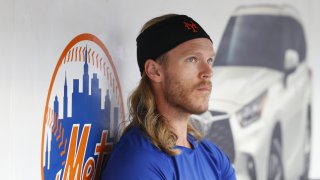 New York Mets pitcher Noah Syndergaard sits in the dugout