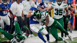 New York Giants running back Sandro Platzgummer (34) runs the ball against New York Jets defensive back Corey Ballentine (27) in the second half of an NFL preseason football game