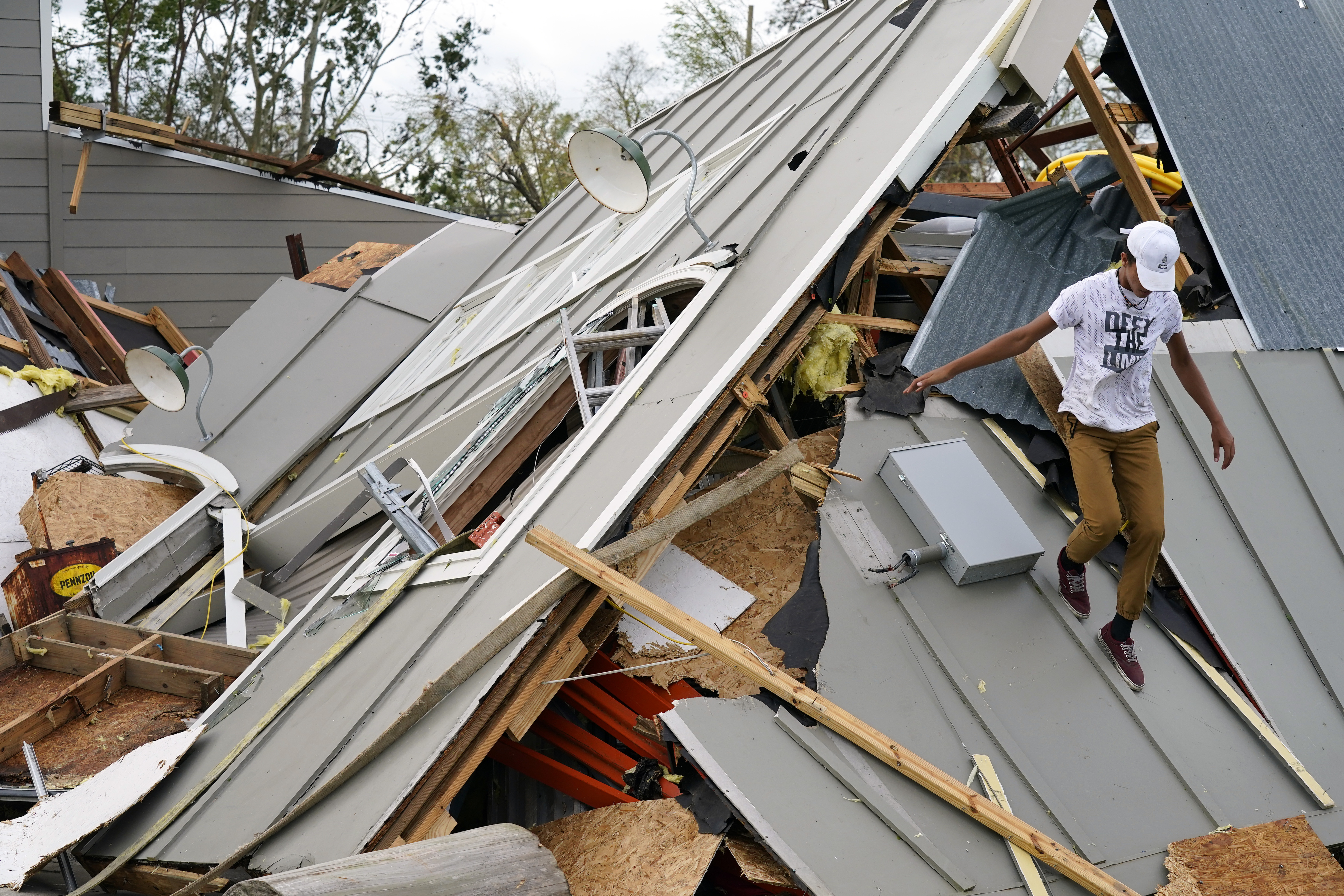 Jeremy Hodges walks onto the remains of their family storage unit in the aftermath of Hurricane Ida, Monday, Aug. 30, 2021, in Houma, La.