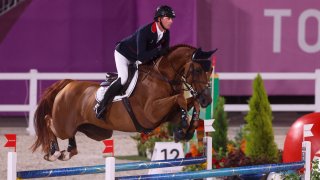 Ben Maher and his horse go over a blue jump