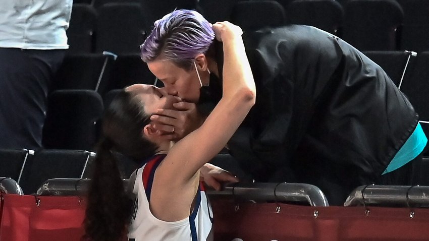 USA’s Sue Bird (L) kisses her partner and USA’s football player Megan Rapinoe after the USA’s victory at the end of the women’s final basketball match between USA and Japan during the Tokyo 2020 Olympic Games at the Saitama Super Arena in Saitama, Japan on Aug. 8, 2021.