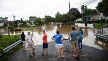 Residents examine flood damage along John Street following flash flooding in the area, as Tropical Storm Henri makes landfall, in Helmetta, New Jersey, on August 22, 2021. - (Photo by TOM BRENNER/AFP via Getty Images)