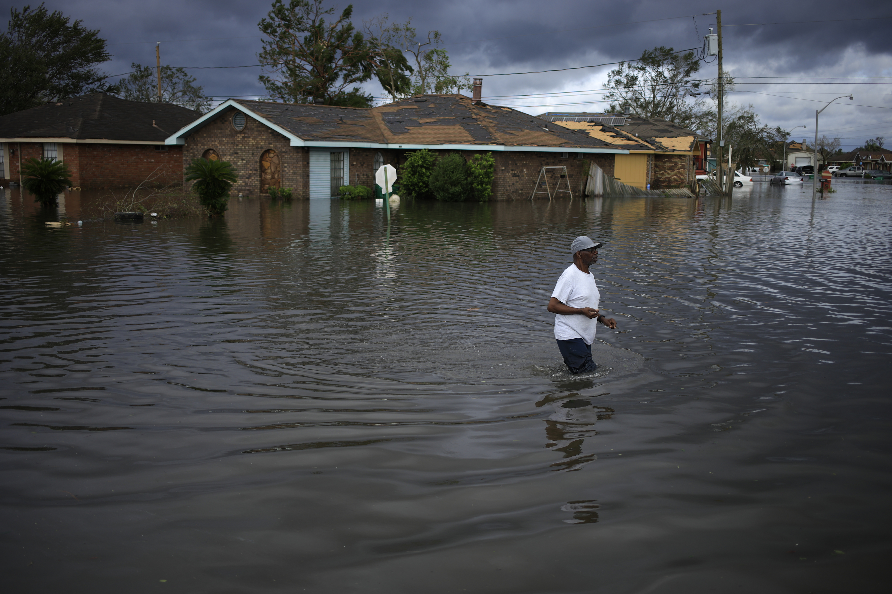 A resident walks through floodwater left behind by Hurricane Ida in LaPlace, Louisiana on Monday, Aug. 30, 2021.