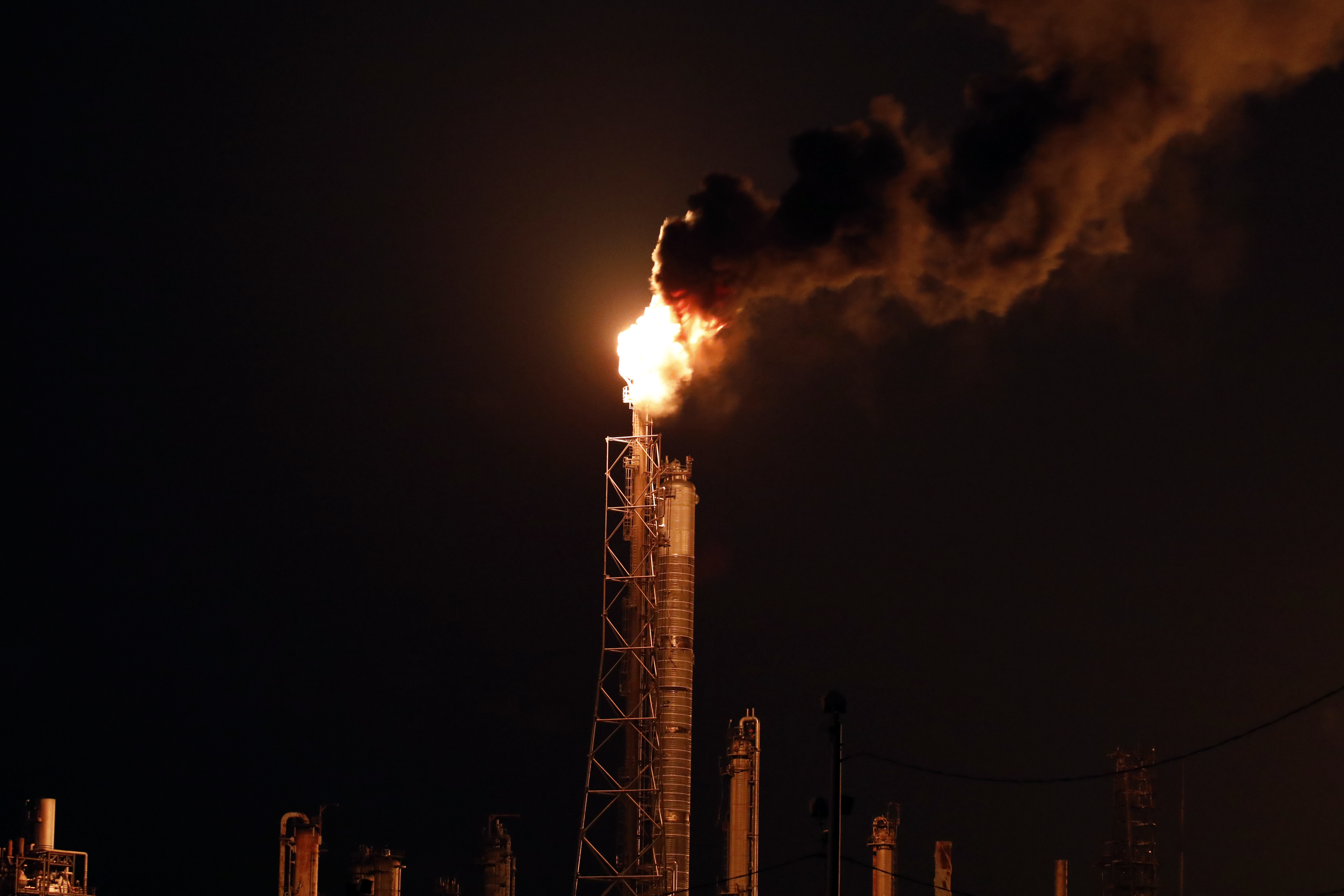 An oil flare burns at the Royal Dutch Shell Norco Refinery during a power outage caused by Hurricane Ida in LaPlace, Louisiana on Monday, Aug. 30, 2021.