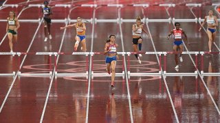 Sydney McLaughlin, centre, of USA on the way to winning the semi-final of the women's 400 metres Hurdles at the Olympic Stadium on day ten of the 2020 Tokyo Summer Olympic Games