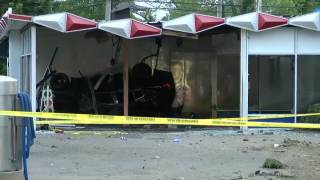 A car lays on its side after crashing into Robo Automatic Car Wash in East Patchogue.