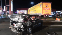 A car with significant back-end damage sits near the truck involved in a chain-reaction crash on Long Island.