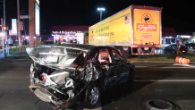 A car with significant back-end damage sits near the truck involved in a chain-reaction crash on Long Island.