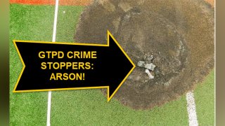 An overhead shot shows an arrow pointing to a charred baseball field devoted to disabled children.