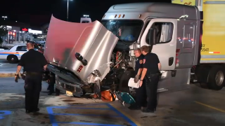 Police inspect a damaged tractor trailer involved in a chain-reaction crash on Long Island.