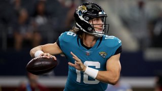 Quarterback Trevor Lawrence #16 of the Jacksonville Jaguars looks for an open receivers against the Dallas Cowboys in the first quarter of the NFL preseason game at AT&T Stadium on Aug. 29, 2021 in Arlington, Texas.
