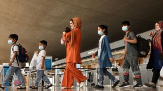 Afghan refugees arrive at Dulles International Airport in Dulles, Virginia, August 31, 2021.