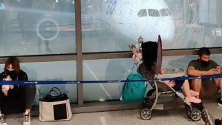 Passengers wait at the terminal as a plane sits on the tarmac during heavy rain at Newark Airport, as local media reported the remnants of Tropical Storm Ida bringing drenching rain and the threat of flash floods and tornadoes to parts of the northern mid-Atlantic, in Newark, New Jersey, September 1, 2021, in this still image taken from video obtained from social media.